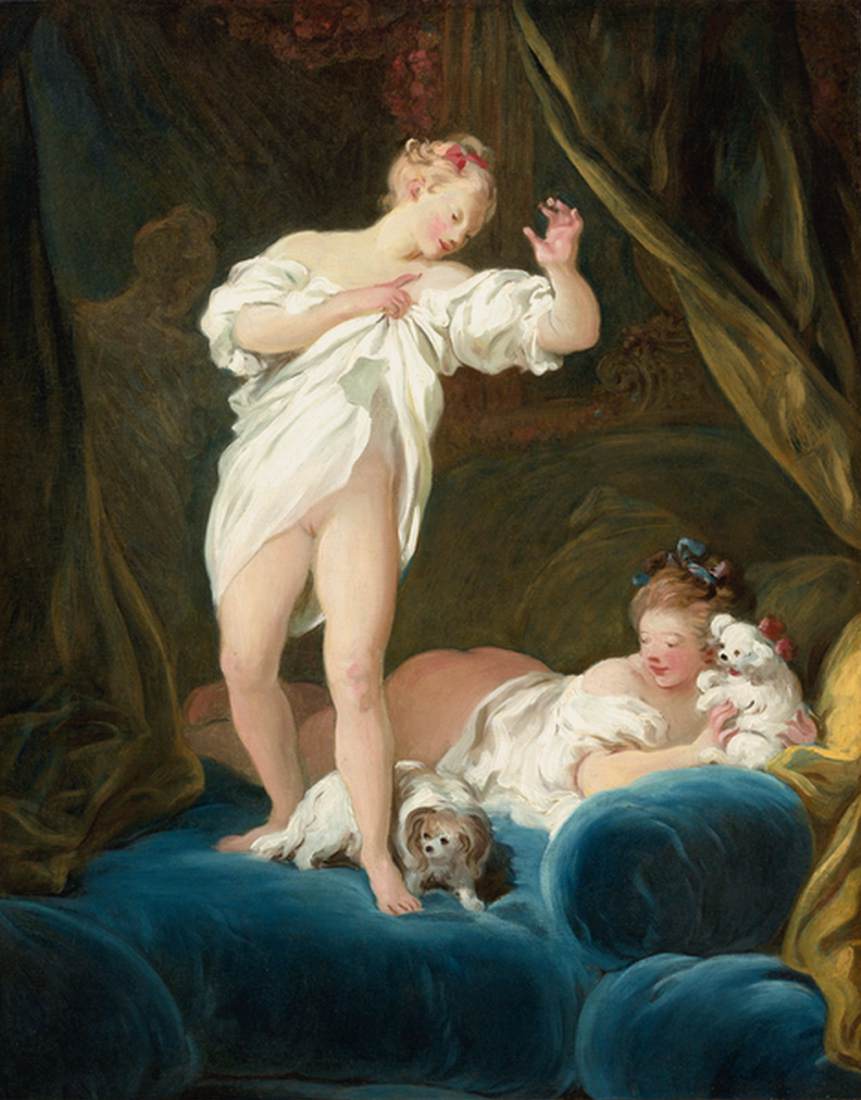 Deux filles sur un lit jouant avec leurs chiens